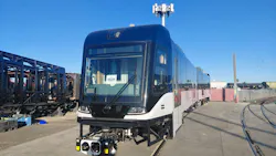 A new Siemens Mobility light-rail vehicle for the Greater Cleveland Regional Transit Authority (GCRTA) sits on a rail yard track under a clear blue sky, featuring a sleek black and white exterior with a modern cab design and roof-mounted equipment, surrounded by industrial yard infrastructure.