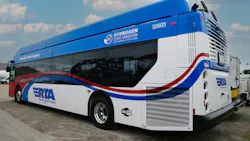 Riverside Transit Agency hydrogen zero-emission bus number 32603 in a patriotic red, white and blue wave livery with stars and stripes graphics, bearing 'Hydrogen Zero Emission — Clean Energy of the Future' branding on the roofline and a Wi-Fi logo on the lower body, parked in a transit yard under a partly cloudy sky.