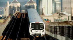 A BART train travels along elevated tracks near downtown Oakland, provided alongside the agency's fiscal year 2026 fourth-quarter rider satisfaction and on-time performance data.