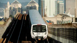 A BART train travels along elevated tracks near downtown Oakland, provided alongside the agency's fiscal year 2026 fourth-quarter rider satisfaction and on-time performance data.