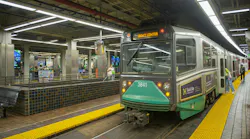 An MBTA Green Line trolley, car 3841, displays 'Gov't Center' as its destination while stopped at Park Street station, with passengers boarding and waiting on the platform.