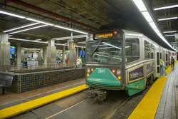 An MBTA Green Line trolley, car 3841, displays 'Gov't Center' as its destination while stopped at Park Street station, with passengers boarding and waiting on the platform.
