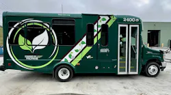 A green Mountain Line Transit Authority bus, unit 2400, featuring 'Powered by Propane' branding, is parked outside a maintenance facility in West Virginia.