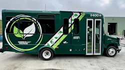 A green Mountain Line Transit Authority bus, unit 2400, featuring 'Powered by Propane' branding, is parked outside a maintenance facility in West Virginia.