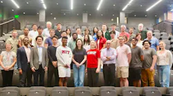 A large group of faculty, researchers and students from the MIT Transit Lab pose together in a lecture hall, with several wearing MIT-branded clothing.
