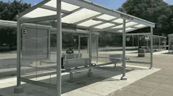 A photo of a new glass-and-steel bus shelter at WMATA's Brookland-CUA station, with digital displays, benches, and the Metro 'M' logo visible, set against a backdrop of trees rendered in color.