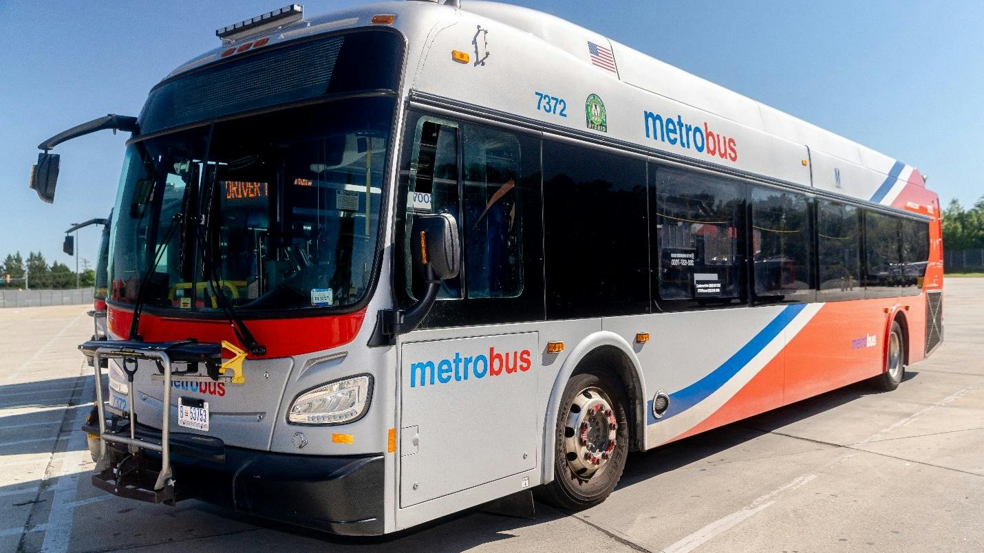 A WMATA NFI bus is photographed from a diagonal angle showing its livery.
