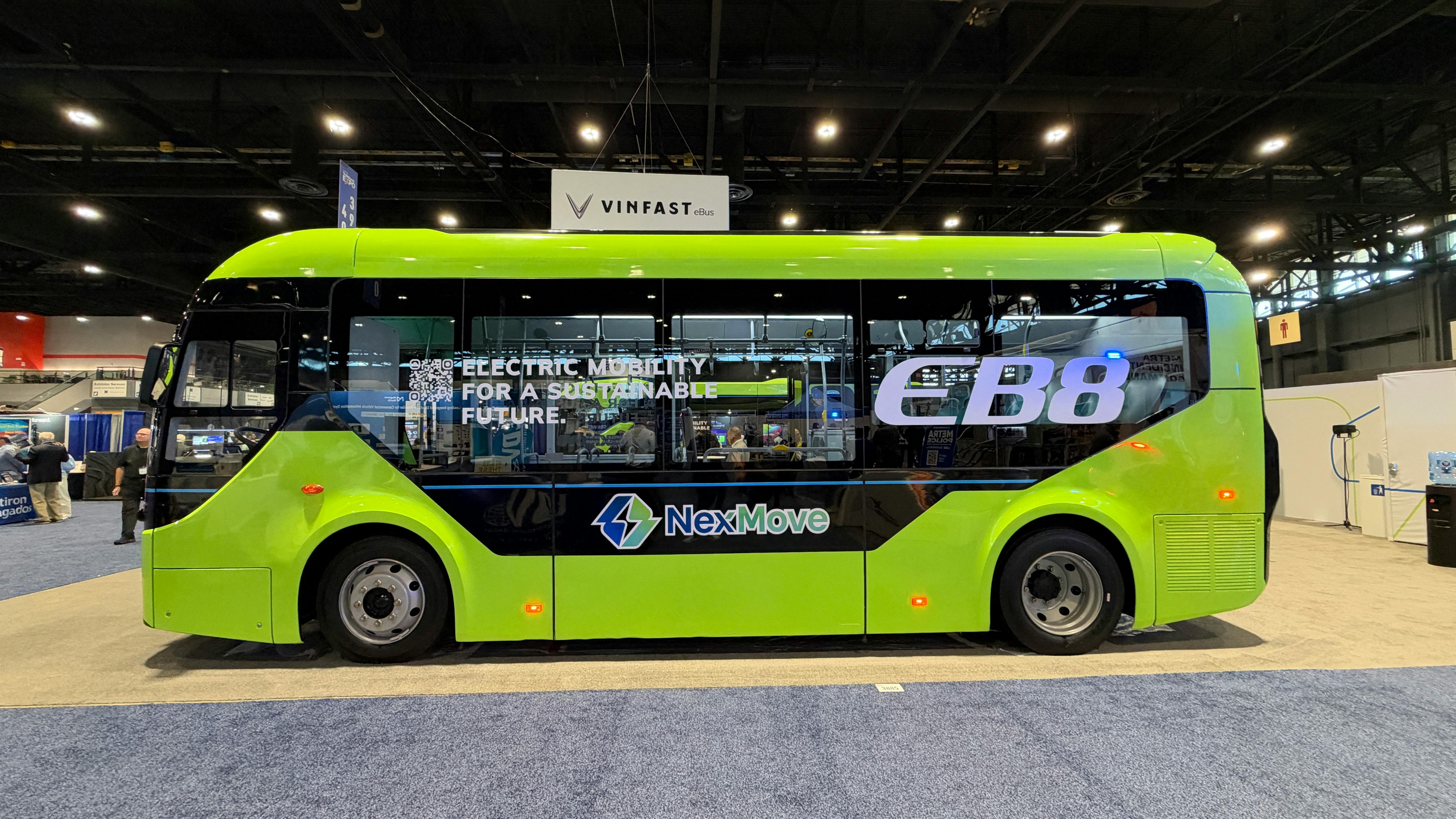 The VinFast EB8 sits on the APTA EXPO show floor bearing green paint an an EB8 and NextMove livery.