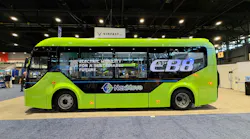 The VinFast EB8 sits on the APTA EXPO show floor bearing green paint an an EB8 and NextMove livery.