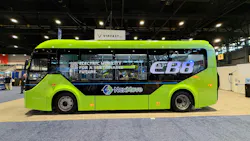 The VinFast EB8 sits on the APTA EXPO show floor bearing green paint an an EB8 and NextMove livery.