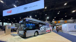 The new Solaris Urbino 40-foot electric bus sits on the APTA EXPO show floor beneath signage for parent-company CAR and Solaris.