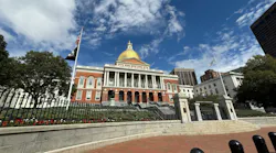 Exterior view of the Massachusetts State House, with its gold dome, under a partly cloudy blue sky.