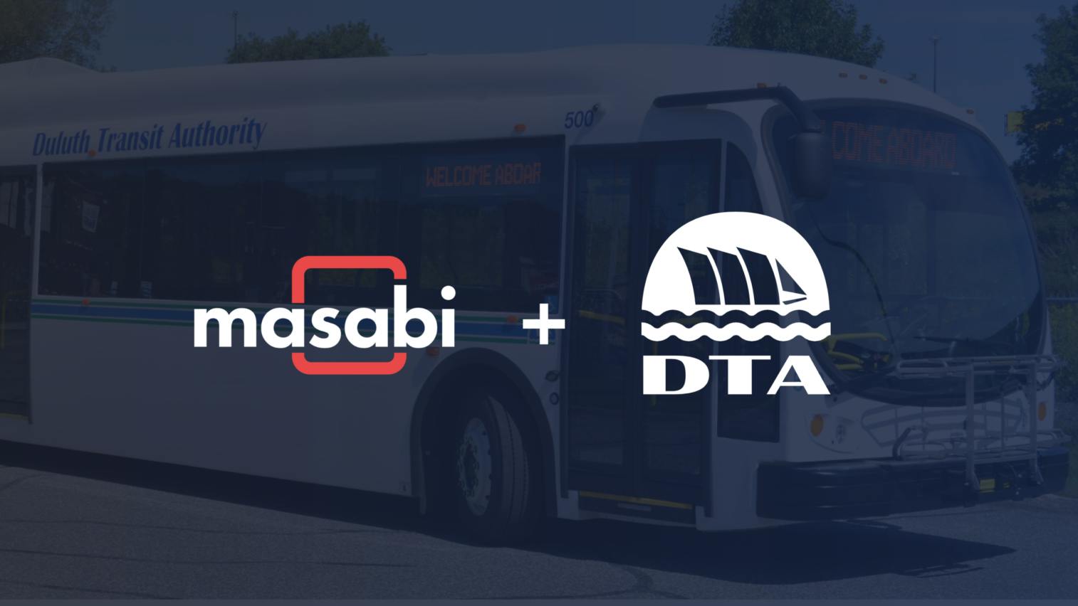 A promotional graphic shows the Masabi logo and the Duluth Transit Authority (DTA) logo side by side with a plus sign, over a darkened photo of a white Duluth Transit Authority bus.