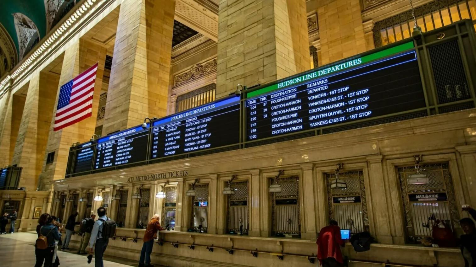 Penta WavWriter-powered digital departure boards at Grand Central Terminal display Harlem Line and Hudson Line train schedules above the MTA Metro-North ticket windows.