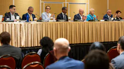 Board members Jason Elliott, Henry R. Perea, Emily Cohen, Anthony Williams, Steve Kawa, Lynn Schenk and Ernest Camacho sit at a long table during a meeting, with several applauding.