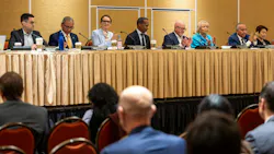 Board members Jason Elliott, Henry R. Perea, Emily Cohen, Anthony Williams, Steve Kawa, Lynn Schenk and Ernest Camacho sit at a long table during a meeting, with several applauding.